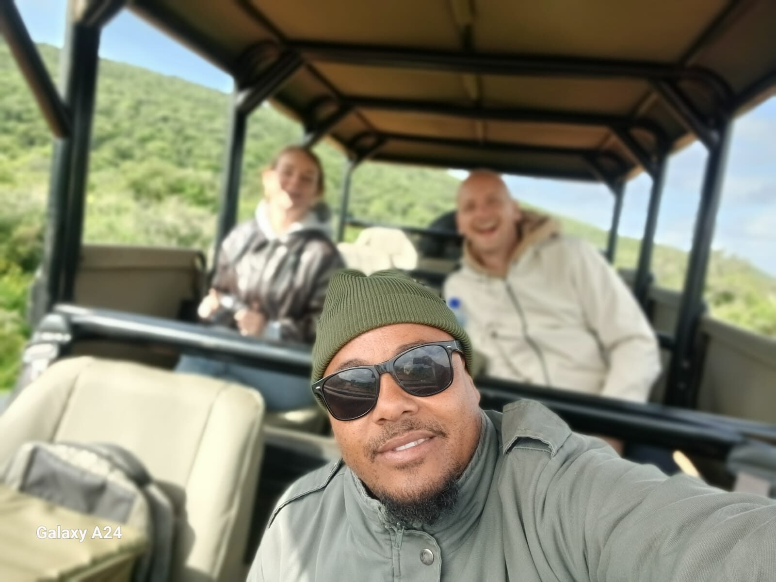 Guide with guests in an open game drive vehicle